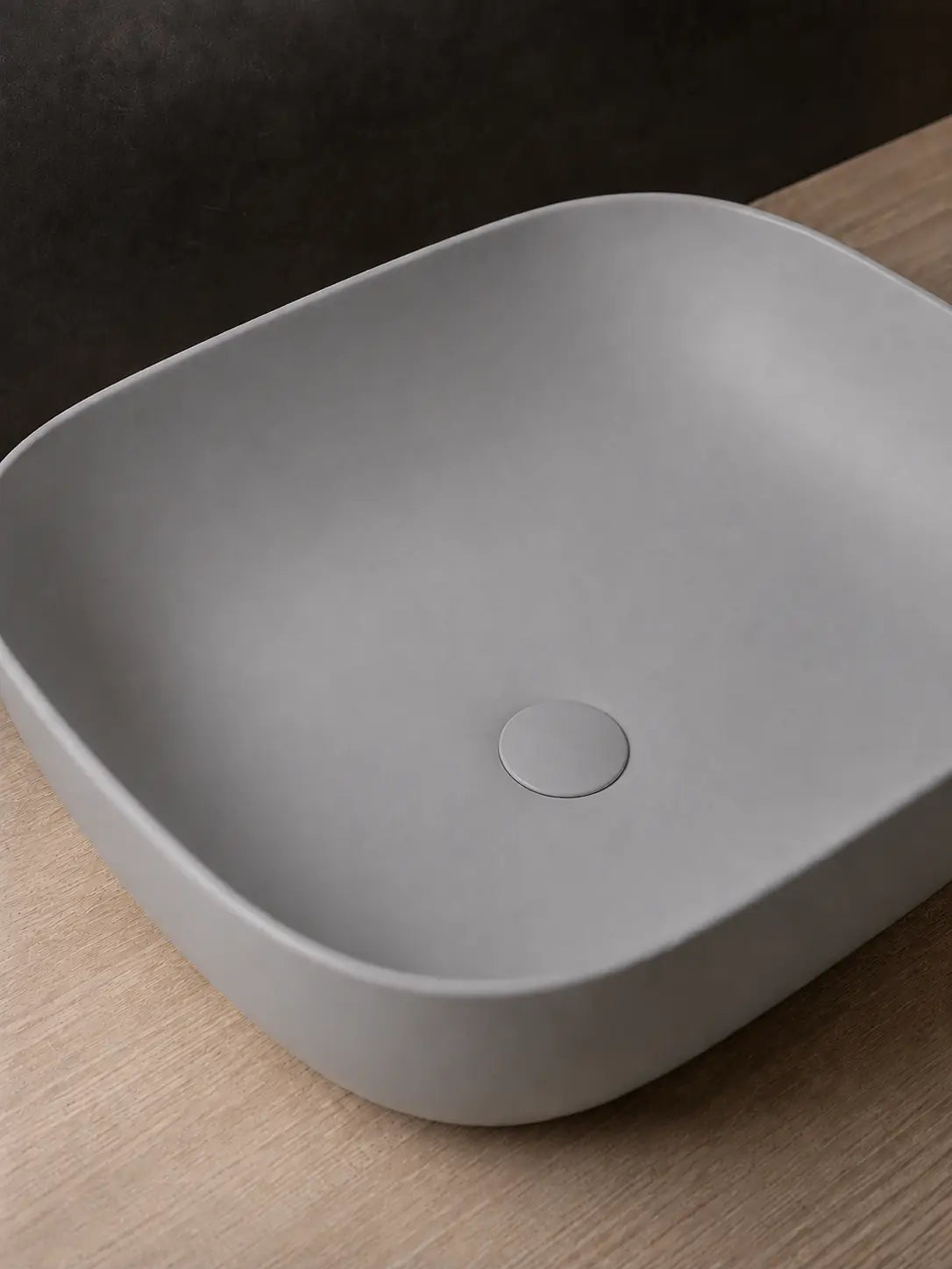 Matching solid matte gray ceramic drain cover on BBbidet 2578 basin