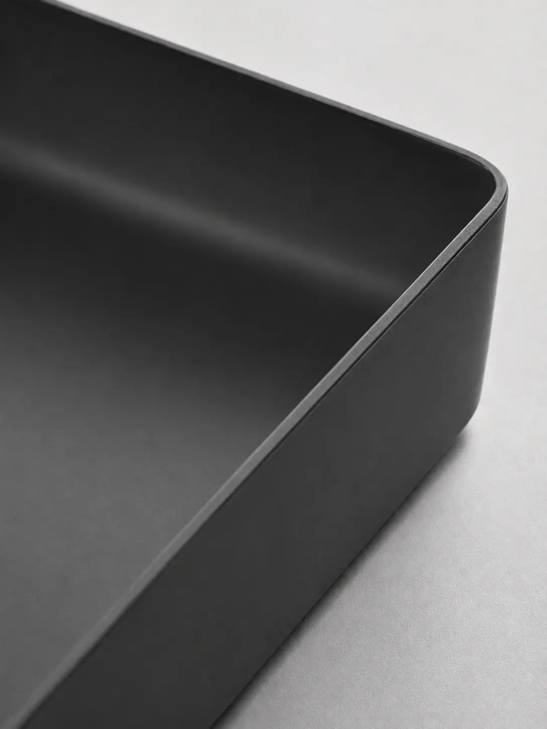 Close-up of the slim rim and matte black ceramic finish on BBbidet 2605 basin