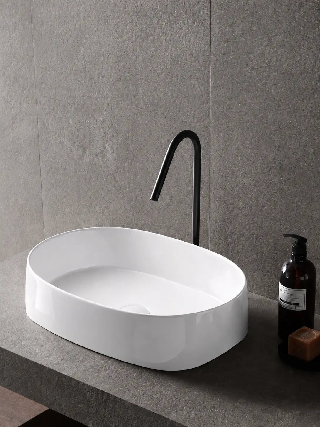 BBbidet 2691M2 glossy white oval countertop basin in a gray stone bathroom