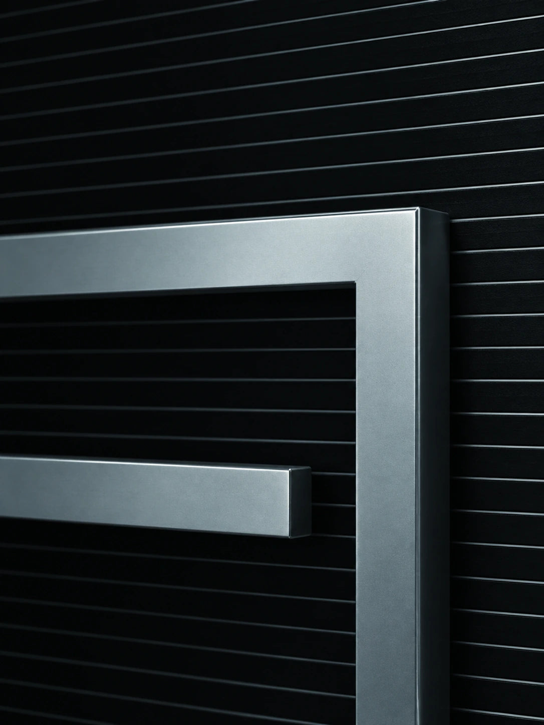 AL101 square corner metal frame detail against black bathroom tile