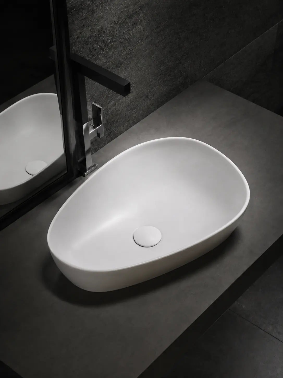 BBbidet V5 matte white asymmetric countertop basin in a dark bathroom vanity setting