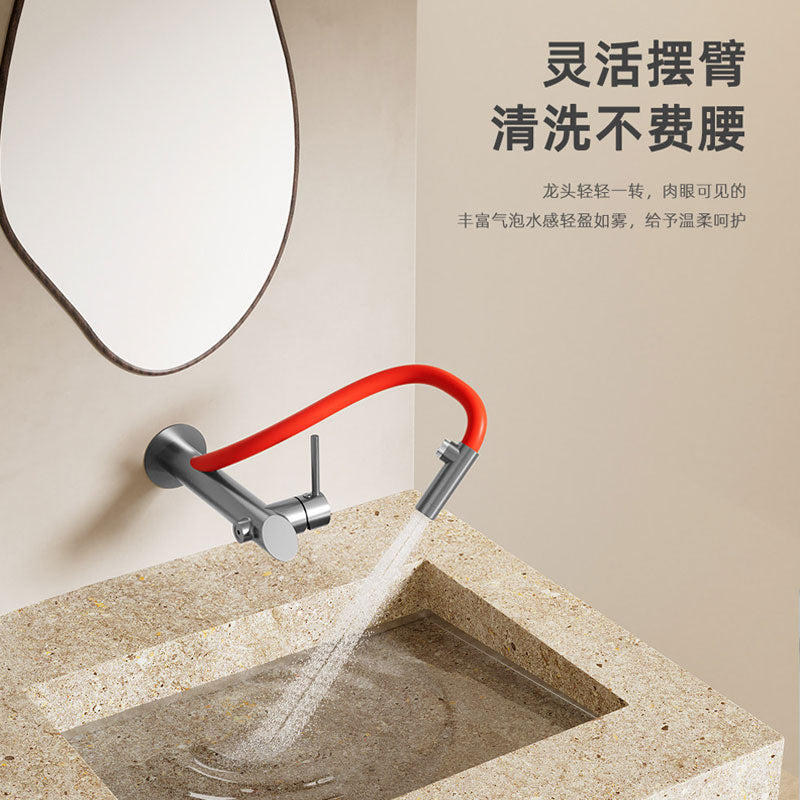 Wall-mounted bathroom faucet with an extended flexible red arm demonstrating a wide-angle aerated bubble spray into a beige terrazzo basin, highlighting ergonomic design and water-saving mist technology