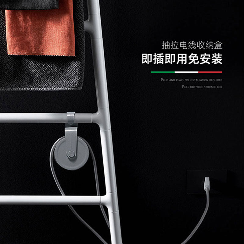 Close-up infographic of a white electric towel rack featuring a gray retractable wire storage box for cord management, showing a plug-and-play connection into a wall outlet against a dark background.