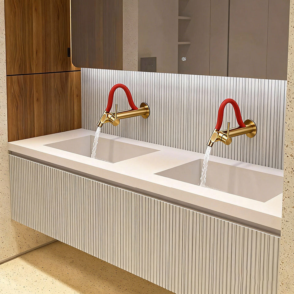 Luxury master bathroom double vanity interior featuring a modern floating cabinet, twin integrated basins, large LED mirror, and two wall-mounted brushed gold faucets with vibrant red flexible necks running water.