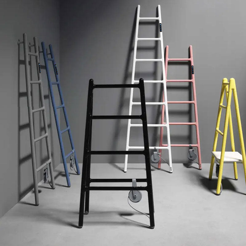 A full product lineup collection of smart ladder-style electric heated towel racks showcasing various colors including matte black, pure white, pastel pink, indigo blue, dark grey, and a vibrant yellow step-ladder design against a neutral background
